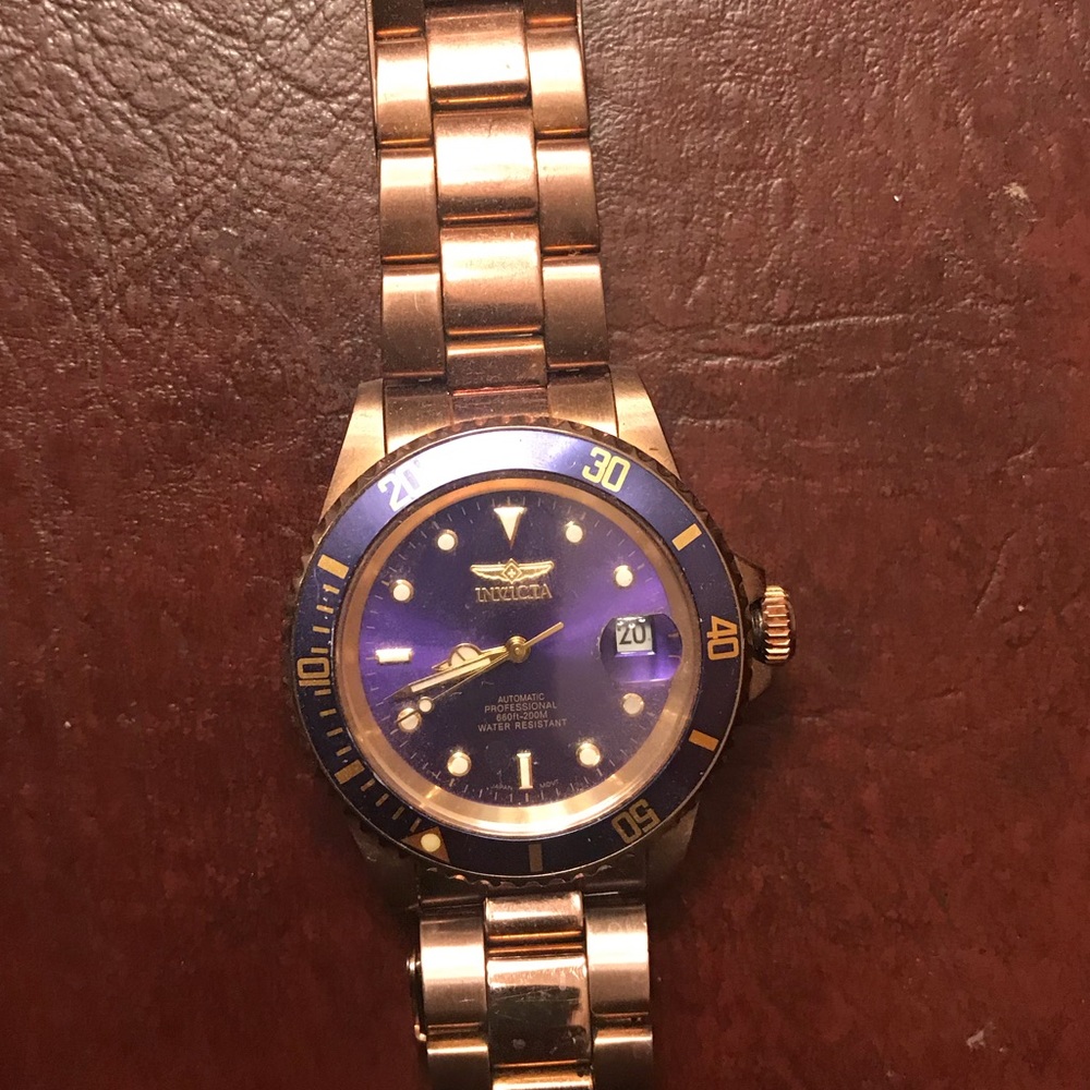 Beautiful gold Invicta men’s watch with blue face.